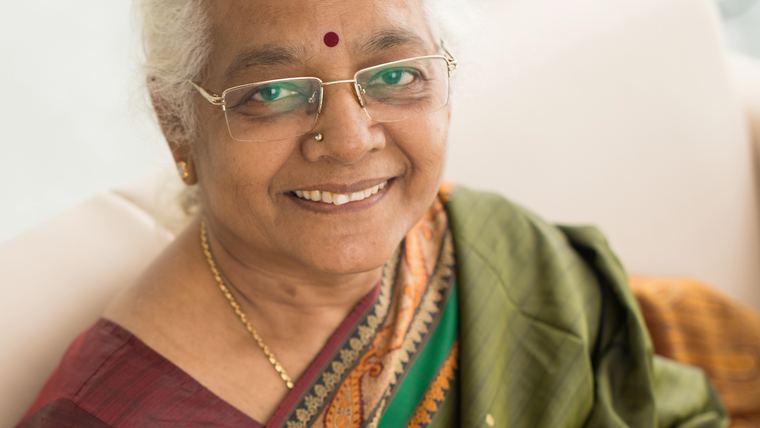 An elderly woman at home with her morning coffee